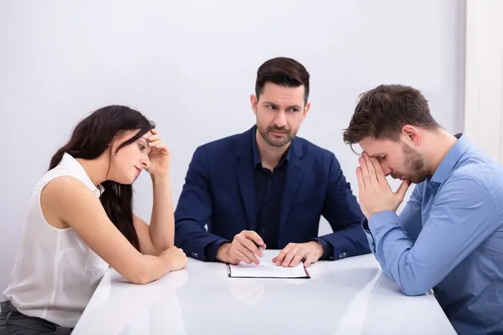 Three people having a serious discussion.