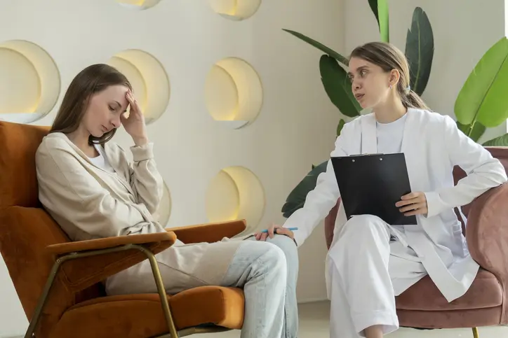 Therapist comforting a distressed woman in session.