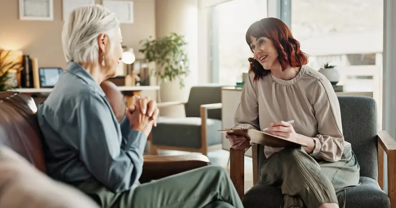 Therapist and patient having a conversation indoors.